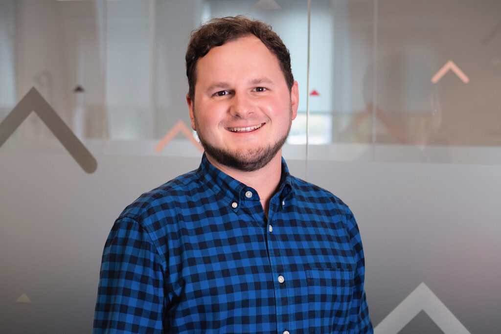 Yordan Dimitrov smiling broadly in a blue checked shirt