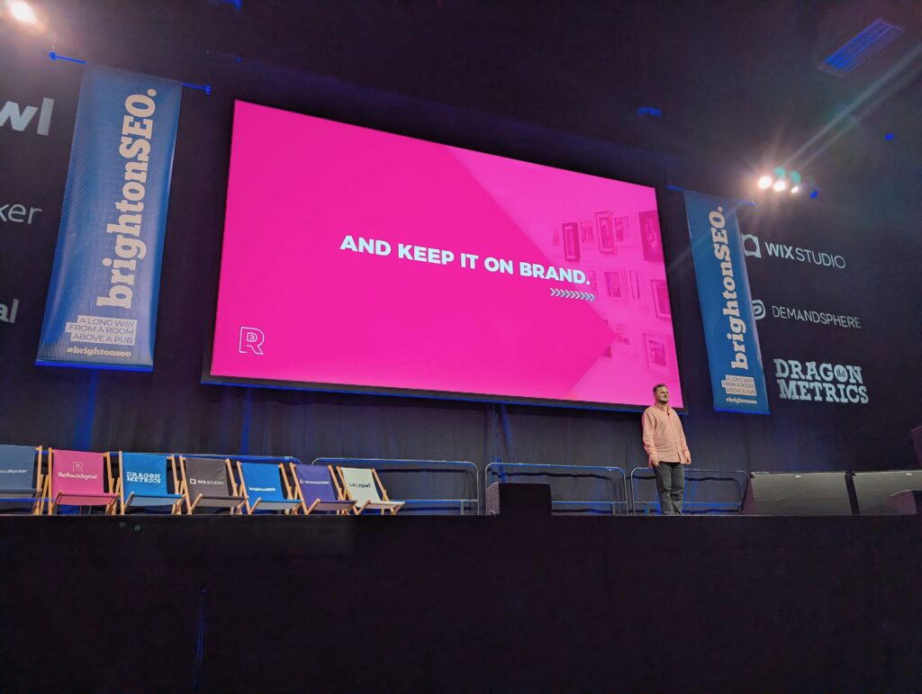 Yordan Dimitrov on a large stage in front of a bright pink slide reading "And keep it on brand."